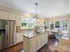 Bright eat-in kitchen boasts stainless steel appliances, granite countertops, and center island with cooktop at 901 Deercross Ln, Waxhaw, NC 28173