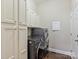 Laundry room with washer and dryer and white cabinets for storage at 901 Deercross Ln, Waxhaw, NC 28173