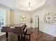 Formal living room featuring a grand piano, large windows, and elegant trim detailing on the walls at 901 Deercross Ln, Waxhaw, NC 28173