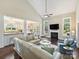 Open-concept living space with a fireplace, vaulted ceiling, and seamless flow to the kitchen and dining area at 901 Deercross Ln, Waxhaw, NC 28173