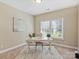 Bright home office with a large window, neutral walls, and decorative rug at 901 Deercross Ln, Waxhaw, NC 28173