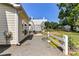 View of the backyard with a patio, white picket fence, mature landscaping, and fresh gravel at 9029 Torrence Crossing Dr, Huntersville, NC 28078