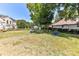 Large backyard with a wooden fence, a variety of potted plants, and mature trees at 9029 Torrence Crossing Dr, Huntersville, NC 28078