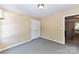 Simple bedroom with neutral carpet, double door closet, and beige walls at 9029 Torrence Crossing Dr, Huntersville, NC 28078