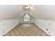A bonus room featuring neutral carpet, an arched window, and easy access to closet space at 9029 Torrence Crossing Dr, Huntersville, NC 28078