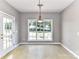 Bright dining area with tile floors, a chandelier, and a view of the backyard at 9029 Torrence Crossing Dr, Huntersville, NC 28078