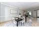 Inviting dining space with tile floors, table with seating, and adjacent living room at 9029 Torrence Crossing Dr, Huntersville, NC 28078