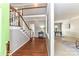 Inviting foyer with hardwood floors, stairs, and an open view to the dining area at 9029 Torrence Crossing Dr, Huntersville, NC 28078