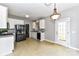 Spacious kitchen with gray countertops, white cabinets, black appliances and exterior door at 9029 Torrence Crossing Dr, Huntersville, NC 28078