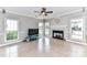 Inviting living room with tile floors, a fireplace, a ceiling fan, and ample natural light at 9029 Torrence Crossing Dr, Huntersville, NC 28078