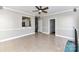 Open floor plan living room with tile floors, access to kitchen and stairs at 9029 Torrence Crossing Dr, Huntersville, NC 28078