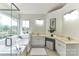 Bright main bathroom featuring a double vanity, soaking tub, and a large window at 9029 Torrence Crossing Dr, Huntersville, NC 28078