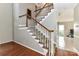 Carpeted staircase with wooden banister and white spindles, leading to the second floor at 9029 Torrence Crossing Dr, Huntersville, NC 28078