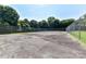 Community tennis court surrounded by a chain link fence and lush greenery at 9029 Torrence Crossing Dr, Huntersville, NC 28078