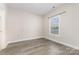 This cozy bedroom features ample natural light and wood flooring at 9271 Meadow Vista Rd, Charlotte, NC 28213