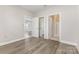 This bedroom boasts wood floors and multiple door access to other rooms at 9271 Meadow Vista Rd, Charlotte, NC 28213