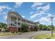 Two-story condo building with brick facade, street view, and multiple covered outdoor porches at 9271 Meadow Vista Rd, Charlotte, NC 28213