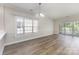 Bright living room featuring hardwood floors, a large window, and sliding doors to a patio at 9271 Meadow Vista Rd, Charlotte, NC 28213