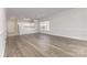 Open-concept living room flowing into the kitchen, featuring hardwood floors and ample natural light at 9271 Meadow Vista Rd, Charlotte, NC 28213