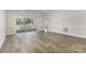 Open living room with hardwood floors and glass doors leading to a private balcony at 9271 Meadow Vista Rd, Charlotte, NC 28213