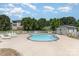 Community pool with surrounding lounge chairs and fenced perimeter offers a relaxing outdoor space at 9271 Meadow Vista Rd, Charlotte, NC 28213