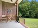 Charming back porch featuring a table, chairs and candle lanterns, ideal for enjoying outdoor scenery at 1011 Duntov Dr, Monroe, NC 28110