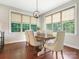 Dining room with wood floors, a modern chandelier, and lots of natural light from large windows at 1011 Duntov Dr, Monroe, NC 28110