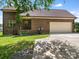 Brick home boasts an attached garage and well-maintained lawn and driveway at 1011 Duntov Dr, Monroe, NC 28110