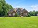 Charming brick home with a well-manicured lawn and landscaping provides excellent curb appeal at 1011 Duntov Dr, Monroe, NC 28110