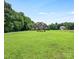 Charming two-story home with landscaped yard and lush green lawn in a peaceful, verdant setting at 1011 Duntov Dr, Monroe, NC 28110