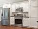 Modern kitchen featuring stainless steel appliances, white cabinetry, and ample storage at 1011 Duntov Dr, Monroe, NC 28110