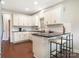 Bright kitchen with white cabinets, dark countertops, and a breakfast bar at 1011 Duntov Dr, Monroe, NC 28110