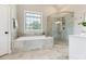 Bathroom with a soaking tub, separate glass shower, and tiled floor at 1011 Duntov Dr, Monroe, NC 28110