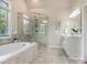 Main bathroom featuring a soaking tub, glass shower, and vanity with drawers at 1011 Duntov Dr, Monroe, NC 28110