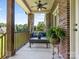 Covered porch with comfortable seating and brick accents, perfect for outdoor relaxation at 1011 Duntov Dr, Monroe, NC 28110