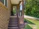 Inviting brick porch with wooden stairs and railing offers a cozy entryway at 1011 Duntov Dr, Monroe, NC 28110