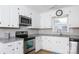 Modern kitchen with stainless steel microwave and oven, granite countertops, and white cabinets at 1140 Mckinnon Dr, Rock Hill, SC 29732