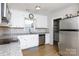 Updated kitchen featuring stainless steel appliances, white cabinets and adjacent pantry/laundry at 1140 Mckinnon Dr, Rock Hill, SC 29732