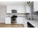 Bright kitchen with stainless steel appliances, granite countertops, white cabinetry and updated fixtures at 1140 Mckinnon Dr, Rock Hill, SC 29732