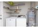 Laundry room equipped with a washing machine, dryer, shelves, and water heater at 1140 Mckinnon Dr, Rock Hill, SC 29732