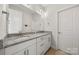 Bathroom featuring double vanity, granite countertops, and white cabinets providing ample storage at 12415 Es Draper Dr, Huntersville, NC 28078