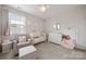 Well-lit Bedroom features a crib, chair, and a dresser, creating a serene atmosphere at 12415 Es Draper Dr, Huntersville, NC 28078