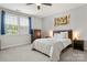 Calm bedroom features a comfortable bed, dresser, and natural light from the window at 12415 Es Draper Dr, Huntersville, NC 28078