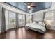 Bright bedroom with bay windows, hardwood floors, and a tray ceiling with unique paint at 12415 Es Draper Dr, Huntersville, NC 28078