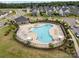 Aerial view of a community pool with lounge chairs, umbrellas, and families enjoying the water at 12415 Es Draper Dr, Huntersville, NC 28078
