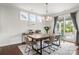 Elegant dining area features a modern chandelier, a table, and chairs at 12415 Es Draper Dr, Huntersville, NC 28078
