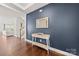 Inviting foyer showcasing hardwood floors, a modern console table, decorative mirror, and access to a living area at 12415 Es Draper Dr, Huntersville, NC 28078