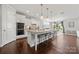Bright open floorplan features a large kitchen island and dining space at 12415 Es Draper Dr, Huntersville, NC 28078