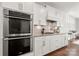 Bright kitchen features white cabinets, stainless steel appliances, and granite countertops at 12415 Es Draper Dr, Huntersville, NC 28078