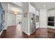 View of the modern kitchen entrance, with stainless steel appliances, white cabinets, and hardwood flooring at 12415 Es Draper Dr, Huntersville, NC 28078